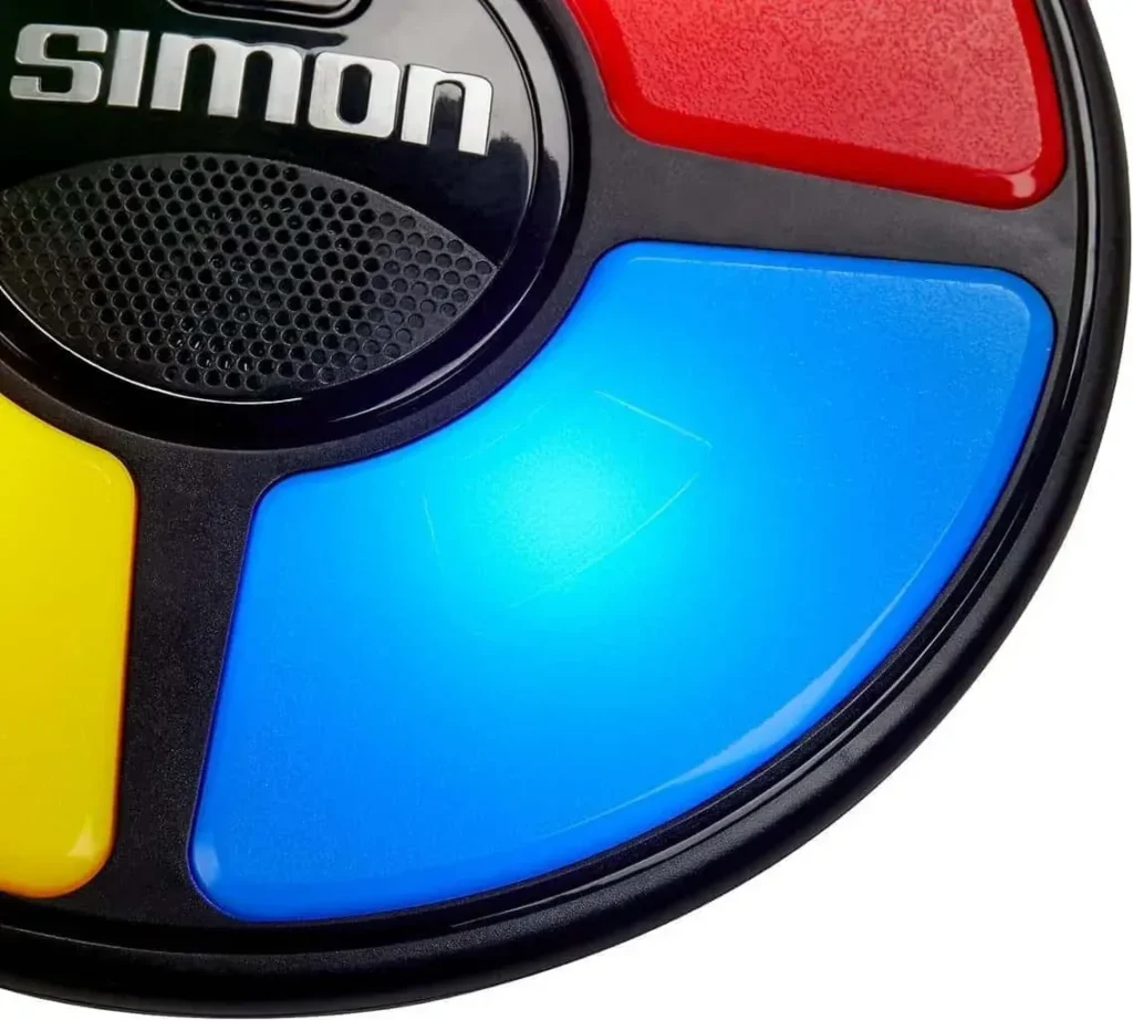 Hasbro Gaming Simon Handheld Electronic Memory Game With Lights and Sounds for Kids Ages 8 and Up, Includes Simon game unit and instructions.