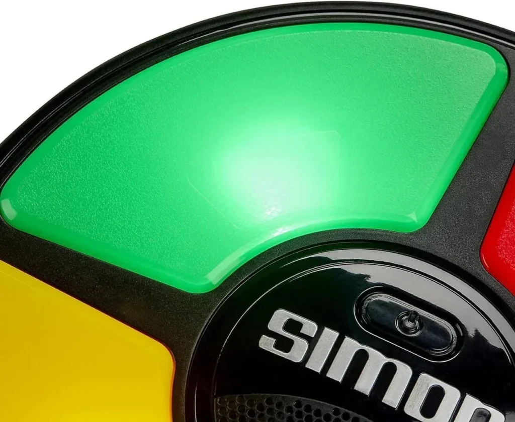 Hasbro Gaming Simon Handheld Electronic Memory Game With Lights and Sounds for Kids Ages 8 and Up, Includes Simon game unit and instructions.